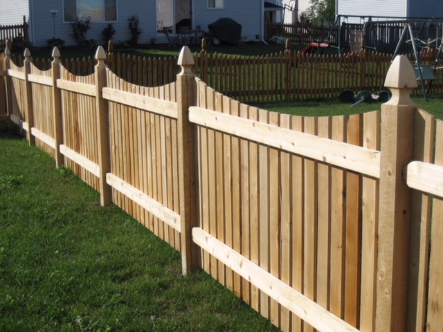 Dipped scallop wood fence with gothic post